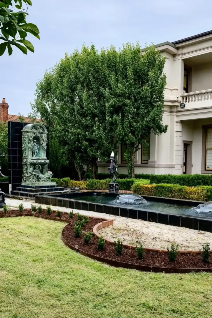 Formal bluestone courtyard with central feature tree and structured hedging, Williamstown
